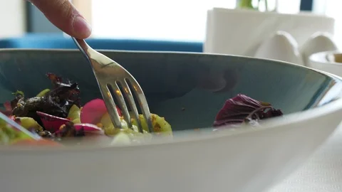 Man eats salad in a cafe, close up, vegetarian food Stock Footage 114358550