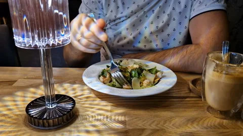 A man eats a seafood salad in a restaurant. Stock-Footage 246278935
