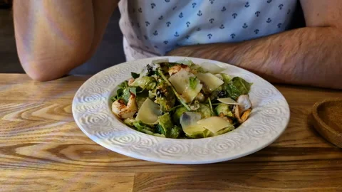 A man eats a seafood salad in a restaurant. Stock Footage 246280261