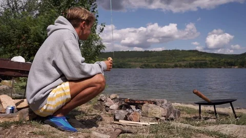 A man eats shawarma on the river bank Stock Footage 114630979