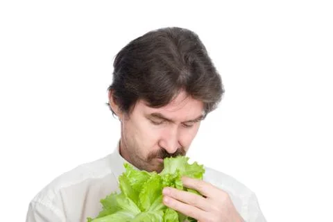 Man eats sheet of the salad Stock Photos