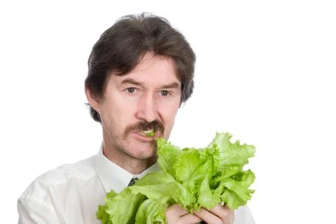 Man eats sheet of the salad Stock Photos