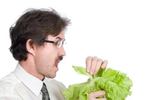 Man eats sheet of the salad Stock Photos