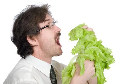 Man eats sheet of the salad Stock Photos