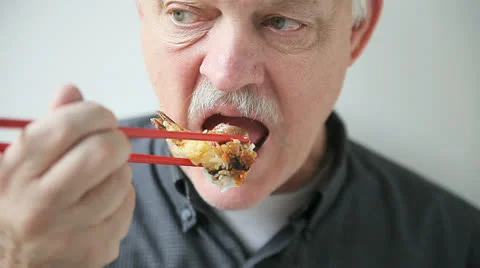 Man eats shrimp sushi Stock Footage 24828995