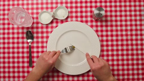 Man eats small green peas with a knife and fork. Extreme diet concept Stock Footage 263859759