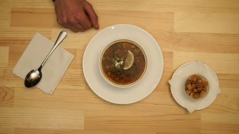 Man eats soup in a cafe Видео 70664204