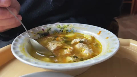 A man eats soup with meatballs. Home cooking. Healthy food. Close-up Stock Footage 233465804