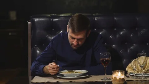 The man eats the soup at the restaurant Stock Footage 70447625