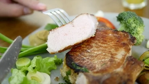 A man eats a steak at home . close-up Stock Footage 83744309