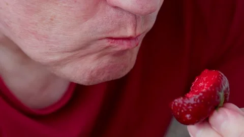 A man eats strawberries Stock Footage 312689390