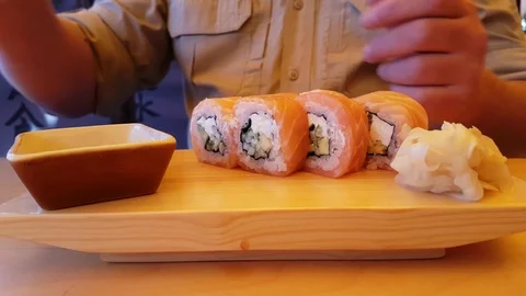 A man eats sushi in a cafe Video stock 80500848