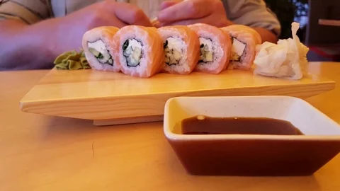 A man eats sushi Stock Footage 80467457