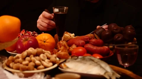 Man eats at the table, different food on black background HD Видео 45907598