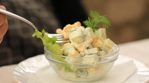 Man eats vegetable salad in a restaurant Stock Footage 111441397