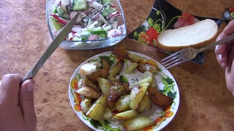 A man eats vegetarian food. Potatoes and Salad Stock Footage 106451234