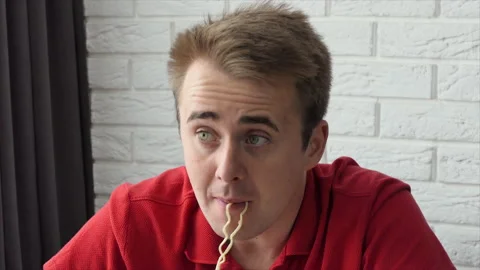A man eats vermicelli, fast food pasta. The guy eats noodles funny. Close-up Stock Footage 195855057