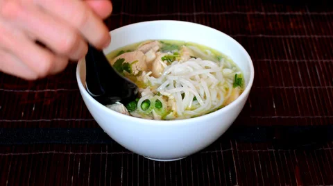 Man eats Vietnamese soup pho Stock Footage 37797196