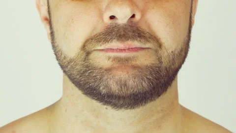 A man eats yogurt with a spoon. Close-up, light background Vídeos de archivo 107500692