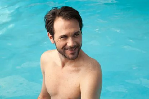Man in the edge of the pool relaxed Stock Photos