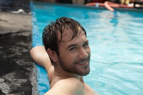 Man in the edge of the pool relaxed Stock Photos