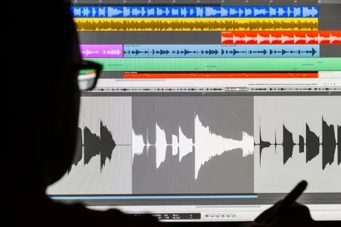 Man editing digital audio on a computer Stock Photos