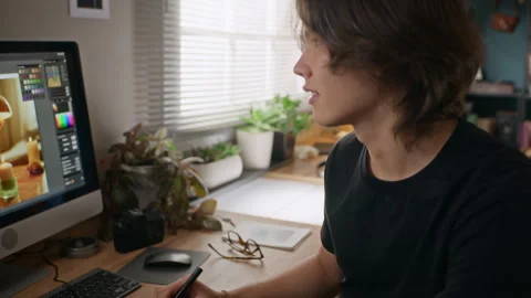 Man Editing Digital Photos on Computer Using Graphics Tablet Stock Footage 341939554