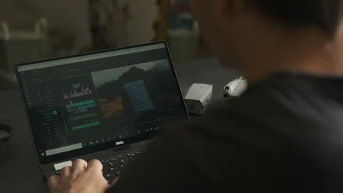 Man edits a video in a room. Drones on the table. Stock Footage 243423668