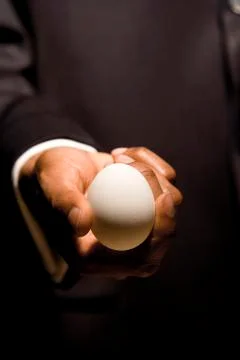 Man with egg in hands Stock Photos