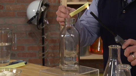 Man egg sucked in a bottle due to change in air pressure Stock Footage 99047546
