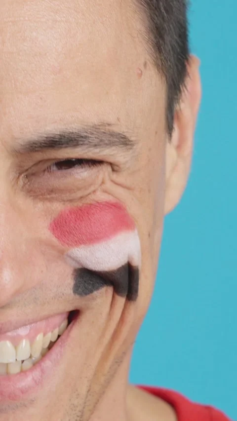 Man with a egyptian flag painted on the face smiling Stock Footage 258822385