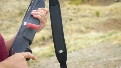 Man Ejects a Shotgun Shell from a Smoking Gun Chamber in Slow Motion Stock Footage 88559214