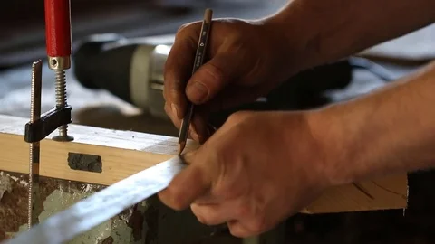 Man with electric jigsaw preparing cutting a piece of wood. Close up. Stock Footage 76146394