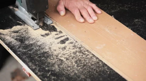 Man with electric jigsaw. Work creates furniture Stock Footage 67578013