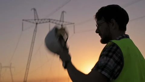 Man electrical engineer with beard puts white protective work helmet on head and 動画素材 201508158