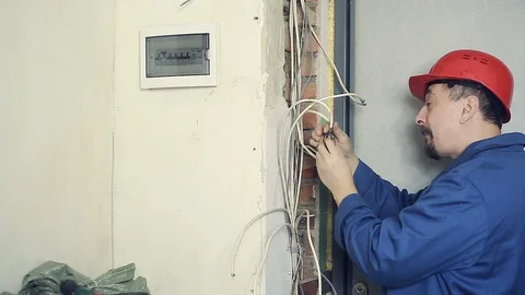 Man electrician performs installation work Stock Footage 99702194