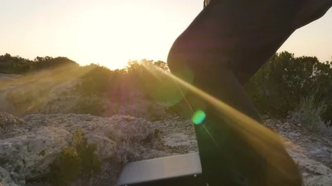 Man in elegant suit with briefcase straightens his tie on top of a cliff on an 스톡 동영상 80225054