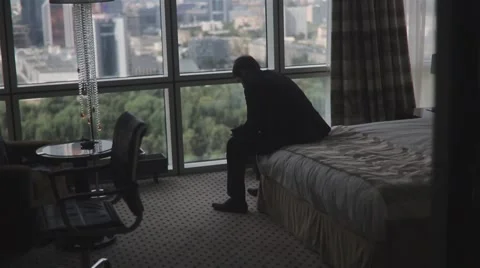 Man In Elegant Suit Sitting On A Bed Video stock 61415391