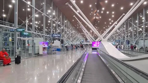 A man on the elevator inside the modern airport Stockbeeldmateriaal 239779907