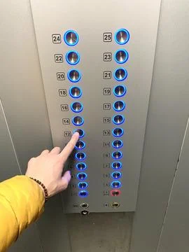 A man in an elevator presses a floor button with his finger. Blue illuminat.. Foto stock