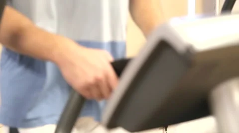 Man on elliptical machine at the gym Stock Footage 63261166