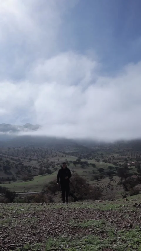 Man Embracing Freedom on Cloudy Mountain, Ait Issafen, Morocco Video stock 332776586