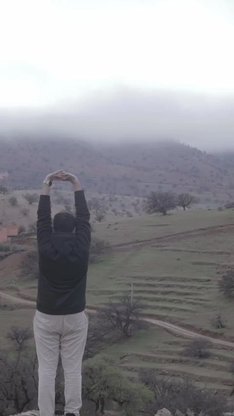 Man Embracing Misty Mountain View, Ait Issafen, Morocco Stock Footage 332772724