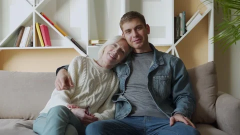 Man embracing smiling middle aged senior mother, relaxing together on Stock-Footage 144103833