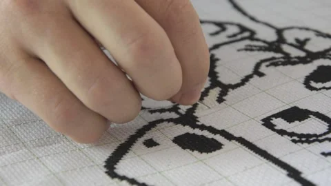 A man embroiders a black thread picture Stock Footage 130400877