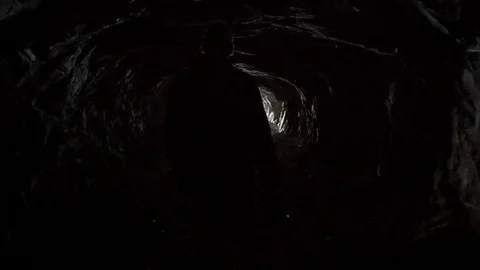 Man emerges from the cave into the light Stock-Footage 72641931