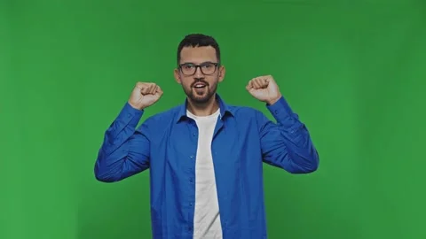 Man emotionally watches something, comments and then rejoices in victory. Green Stock Footage 172439863