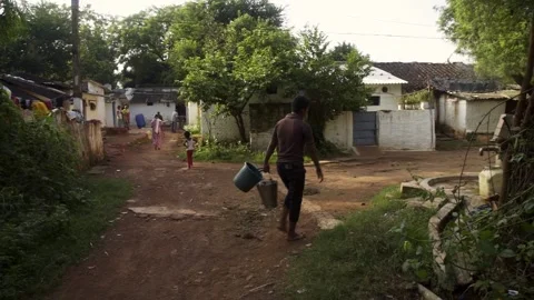 Man with empty bucket going to collect water from handpump Stock Footage 162078622