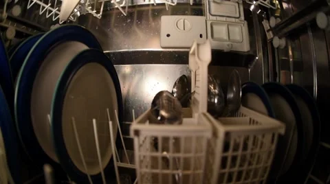 Man emptying dishwasher in kitchen Stock Footage 54576420