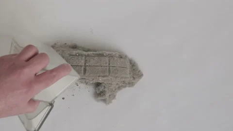 Man is emptying dust bin of an automatic vacuum cleaner Stock Footage 147040722